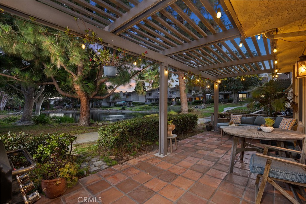 Brick loggia and garden overlooking the pond, the auction setting